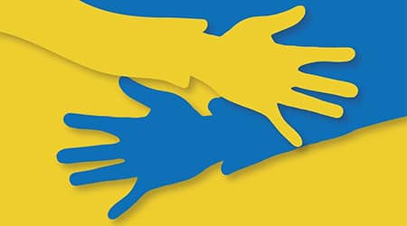 Grafika przedstawiająca dwie dłonie w barwach ukraińskich.